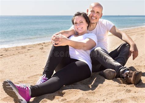 Man And A Middle Aged Woman Sitting On The Beach Stock Image Image Of German Dating 100447997
