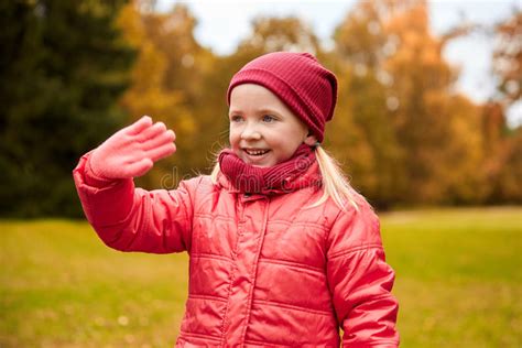 Happy Little Girl Waving Hand In Autumn Park Stock Photo Image Of