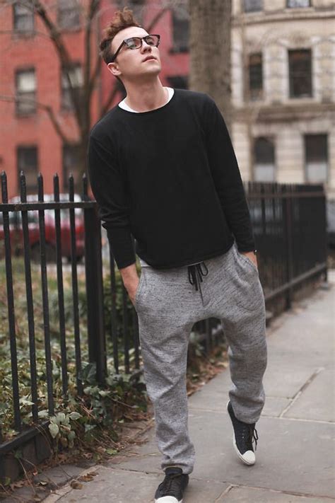Grey Sweatpants Styled With Black Full Sleeves Tshirt And A Pair Of Black Sneakers Gives A
