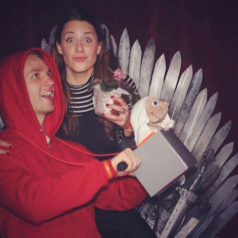 Two People Sitting On A Game Of Throne With Stuffed Animals In Their