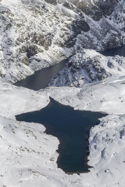 Aerial View Of The Alpine Lago Di Lei Surrounded By Snow