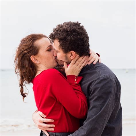free photo couple kissing on sea shore