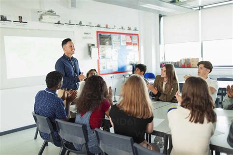 High School Students Clapping For Teacher In Debate Class Stock Photo