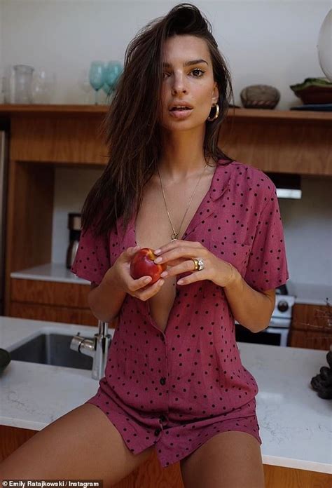 Emily Ratajkowski Looks Sultry As She Poses Bra Free While Clutching An Apple In The Kitchen