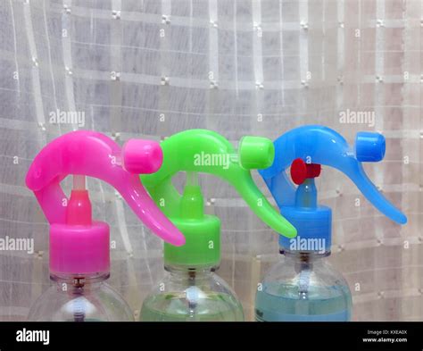 Three Sprayers Red Green Blue Color On Window Sill Close Up Stock Photo