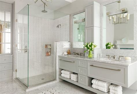 Then, incorporate white as a balance through the sink, hand towels, and picture frame. Cool And Sophisticated Designs For Gray Bathrooms