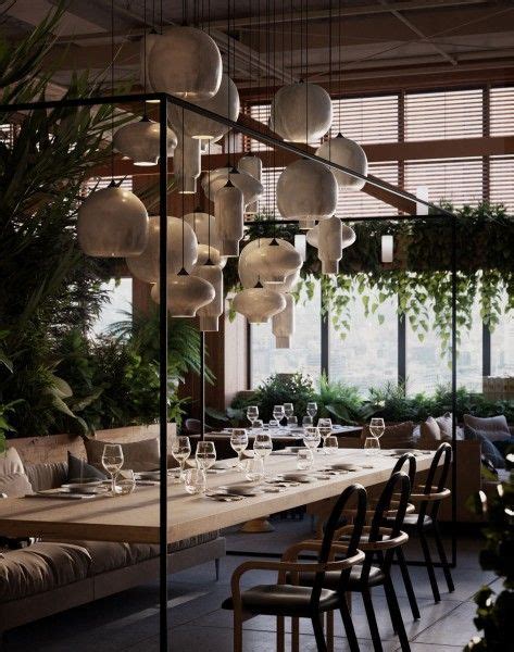 An Indoor Dining Area With Tables Chairs And Potted Plants Hanging