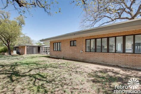 The exterior renovation of the home includes a pop of bright turquoise on the door and natural wood panels on the side of the carport. Stunning 1955 midcentury modern house in Fort Worth ...