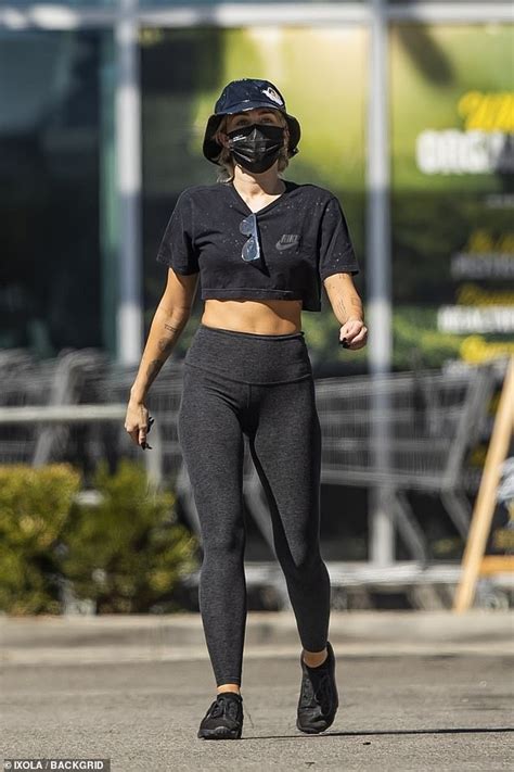 Miley Cyrus Bares Her Toned Tummy In A Crop Top And Leggings For