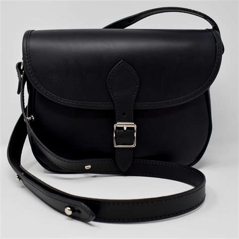 Our Black Leather Saddle Bag Featuring A Strathspey Tweed Lining Is