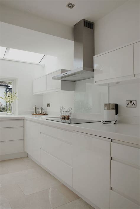 Darker colors near the ceiling can make the ceiling seem lower than it actually is, especially if you. Minimal white gloss kitchen with solid surface worktops p ...