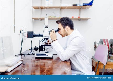 Scientist With Microscope Examining Samples And Contaminated Probes In