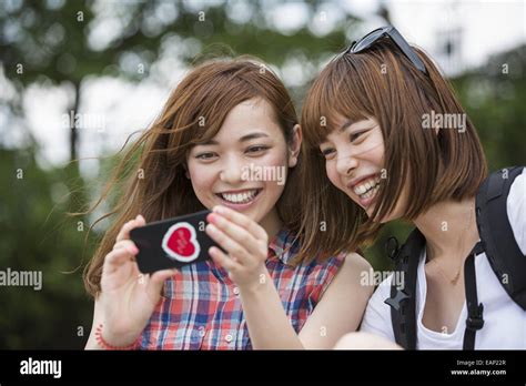 Two Women Friends Taking A Selfie In The Park Stock Photo Alamy