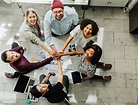 Download premium image of Happy team stacking hands on a creative ideas ...