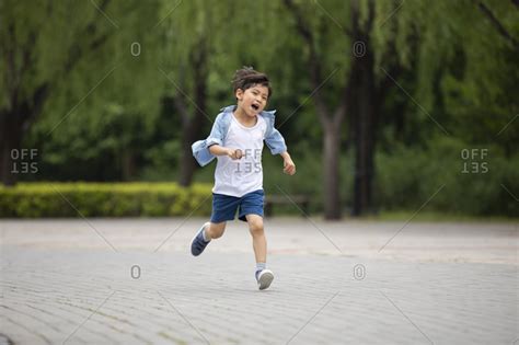 Little Boy Running In Park Stock Photo Offset