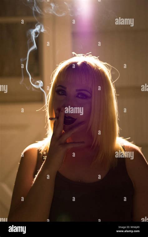 Portrait Of Young Woman Smoking Cigarette Stock Photo Alamy