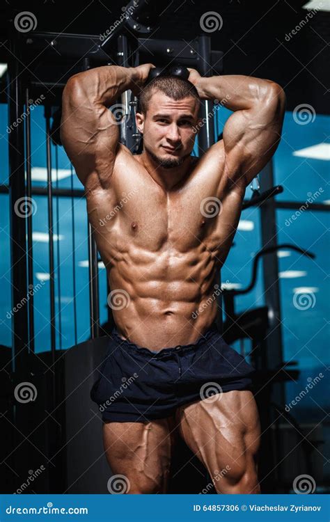 Strong Athletic Man Fitness Model Torso Showing Muscles In Gym Stock