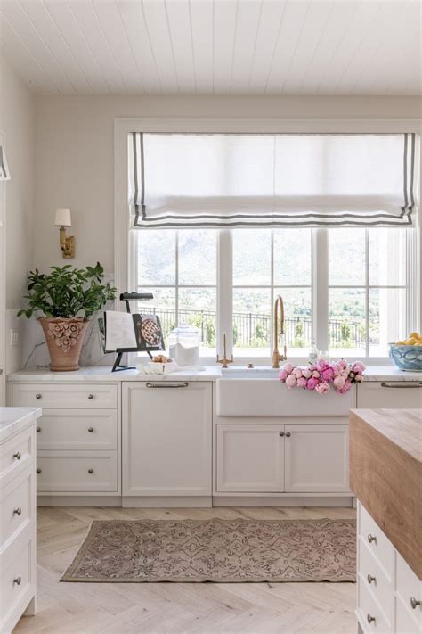 Fitted with glass panels, a light blue door with a brass doorknob opens to a white kitchen pantry featuring white cabinets finished with a honed marble countertop and dark nickel knobs. Step Inside my Kitchen... - Rach Parcell in 2020 | Home, Interior, Interior design