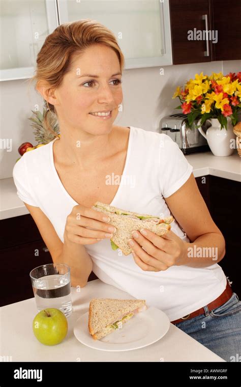 Woman In Kitchen Eating Lunch Stock Photo Alamy