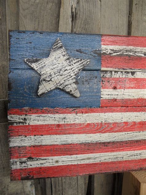 An American Flag Painted On Wooden Planks In Front Of A Wood Fence With