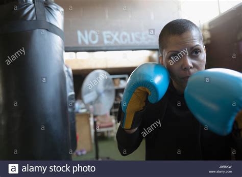 Portrait Serious Tough Female Boxer In Boxing Gloves In Fighting