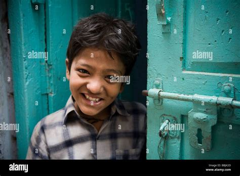 Delhi India Portrait Of Boy Smiling At Camera From Doorway Stock