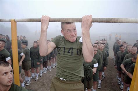 A Marine Corps Recruit Does Pull Ups During A Physical Fitness Test At