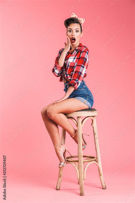 Full Length Portrait Of An Excited Brunette Pin Up Girl Stock Photo