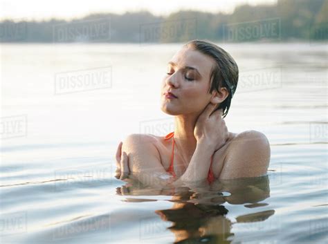 Caucasian Woman Swimming In Still Lake Stock Photo Dissolve