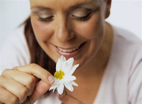 Woman Plucking Petals Of Flower Stock Photo