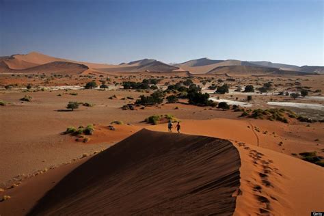Two People Are Walking In The Sand Dunes