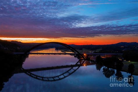 Aerial View Of The 360 Pennybacker Bridge And Reflection Over Lake