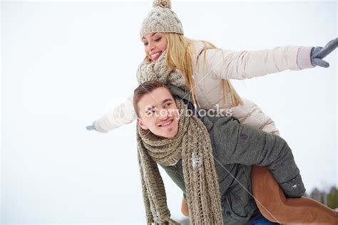 Man Carrying His Girlfriend On Shoulders Royalty Free Stock Image