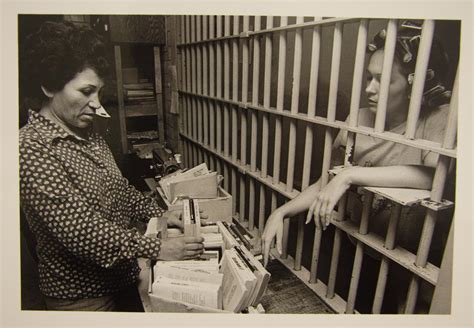 Female Travis County Jail Worker Offering Books To A Female Inmate