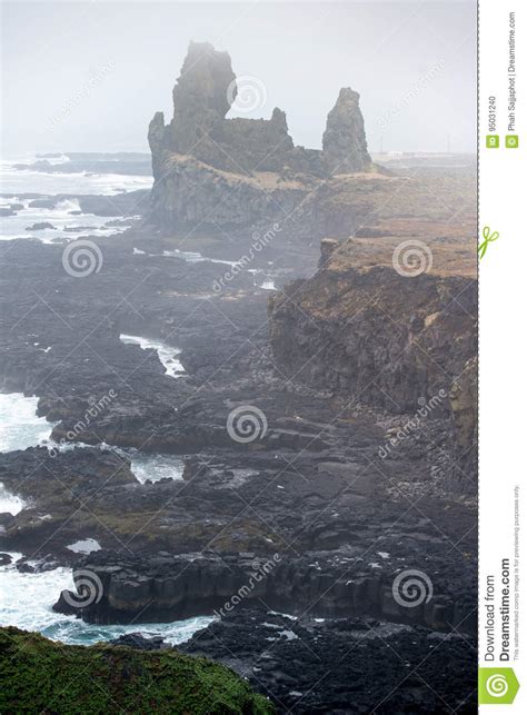 Vertical Londrangar Basalt Cliffs Dramatic Fog In Iceland Stock Photo