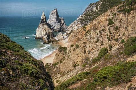 Bizarre Rocks At Praia Da Ursa Beach Sintra Portugal Towering Cliffs And Atlantic Ocean Waves