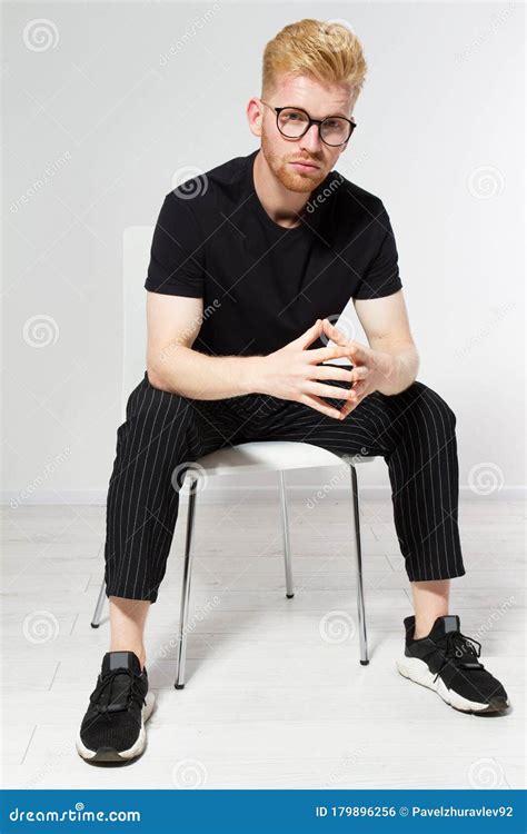 Young Man On A Chair Portrait Of Handsome Young Man Sitting On A Chair