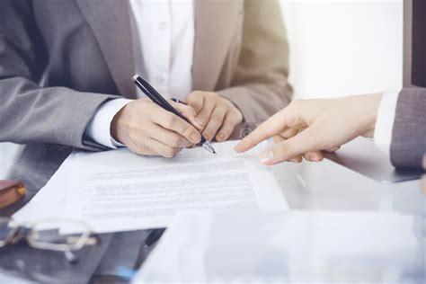 Businesswoman Signing Contract Papers Group Of Business People At