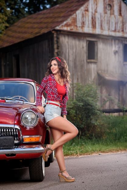 Pin Up Girl Posing Near Red Vintage Car In The Countryside Premium Photo