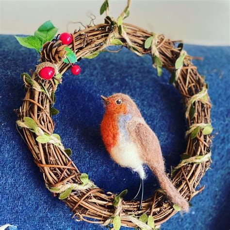 A Small Bird Sitting On Top Of A Wreath
