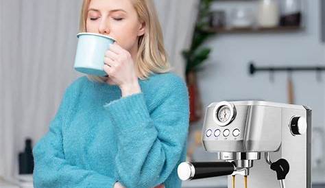 a woman drinking from a cup next to a coffee maker