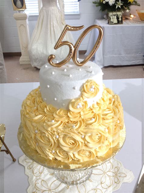 50th Anniversary Cake Of Creamy Yellow Rosettes With White Top Layer