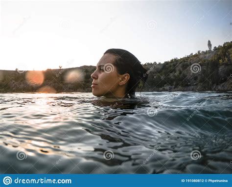 Young Pretty Woman Swimming In Lake Water On Sunset Stock Photo Image