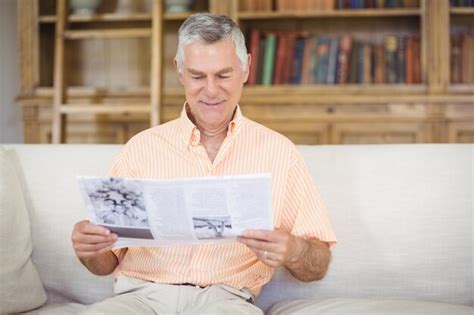 Premium Photo Senior Man Reading Newspaper In Living Room