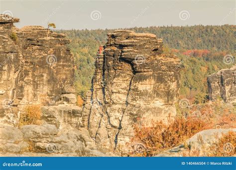 Elbe Sandstone Mountain In Autumn With Mountain Climber In Sunshine
