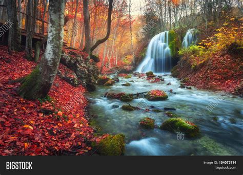 Autumn Forest With Waterfall At Mountain River At Sunset
