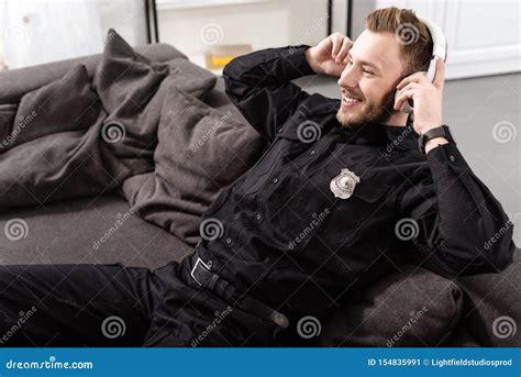 Policeman Putting Handcuffs On Drug Dealer In Abandoned House Catching Criminal Stock Image