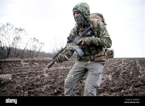 Military Mercenary Wearing Hooded Camo Jacket And Backpack Walking
