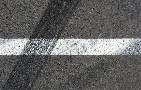 Asphalt Texture With White Line And Tire Marks Top View Stock Photo