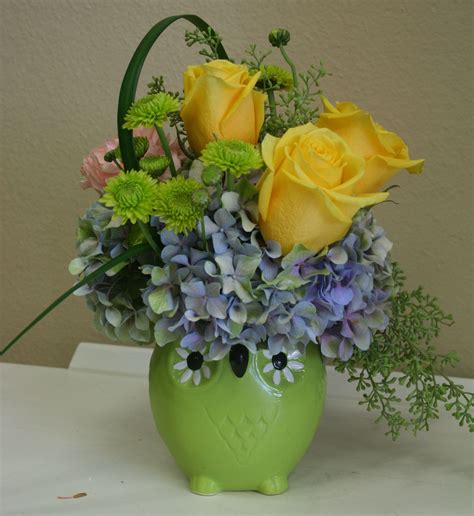 A Mixed Flower Arrangement Including Roses And Hydrangea In A Ceramic